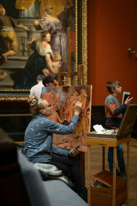 Woman and child paint in an art museum.